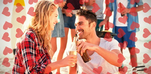 Couple sitting on sand at beach — Stock Photo, Image