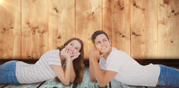 Couple lying on floor and looking away — Stock Photo, Image