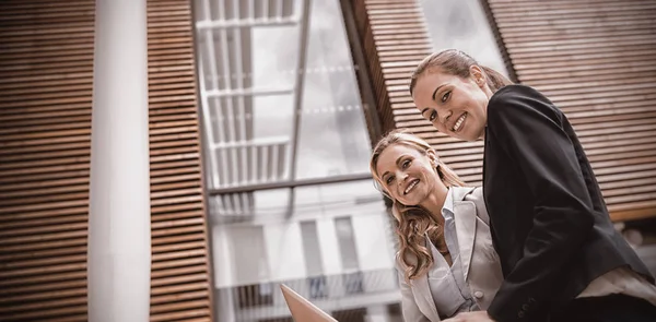 Businesswomen with laptop in office premises — Stock Photo, Image