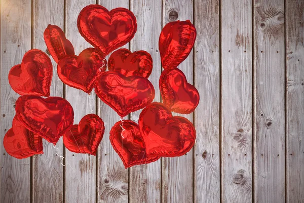 Heart balloons against wooden planks — Stock Photo, Image