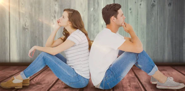Пара, сидящая на полу спиной к спине — стоковое фото