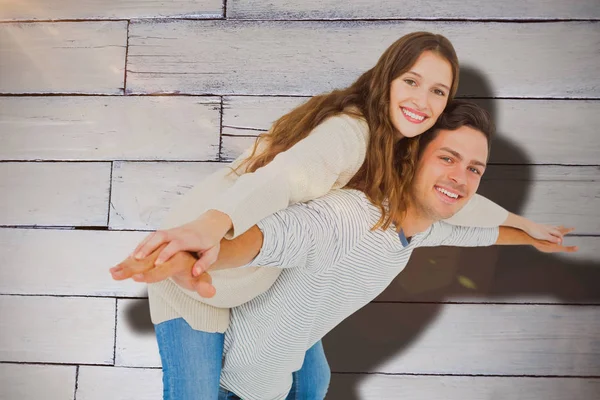 Man giving piggy back to his girlfriend — Stock Photo, Image