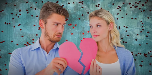 Couple holding halves of broken heart — Stock Photo, Image