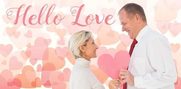 Couple holding pink heart shape — Stock Photo, Image