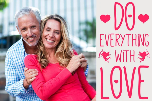 Smiling couple against grey background — Stock Photo, Image