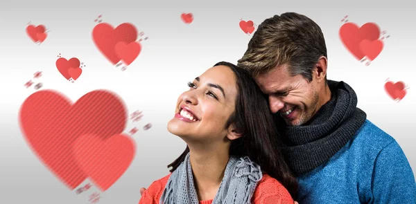 Smiling couple against grey background — Stock Photo, Image