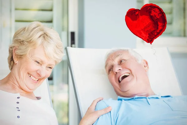 Couple relaxing on lounge chair — Stock Photo, Image