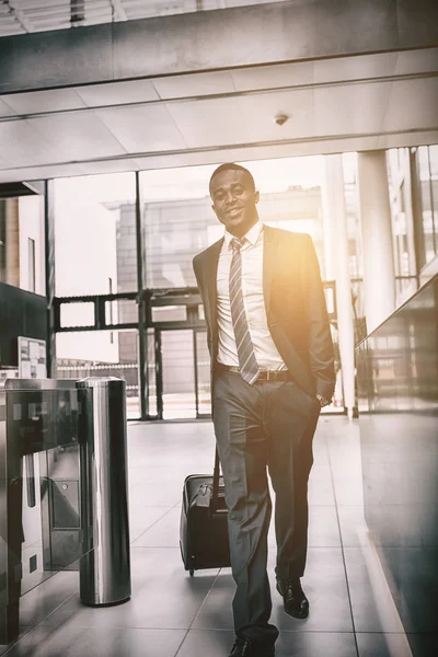 Businessman walking with suitcase — Stock Photo, Image