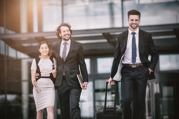 Empresária com colegas caminhando — Fotografia de Stock