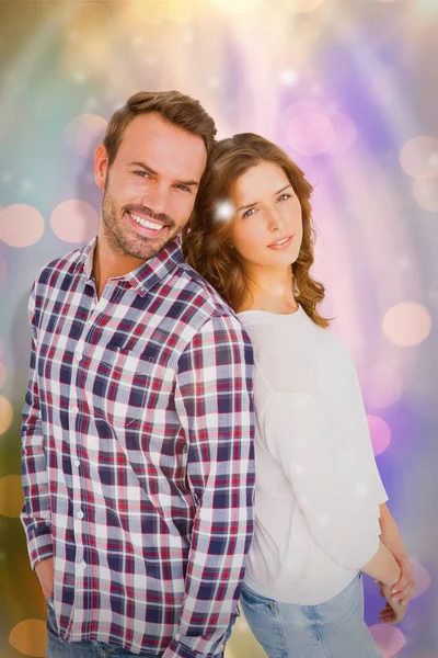 Young couple standing back to back — Stock Photo, Image