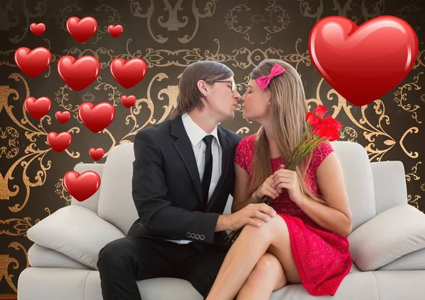 Romantic couple in love while sitting on a sofa — Stock Photo, Image