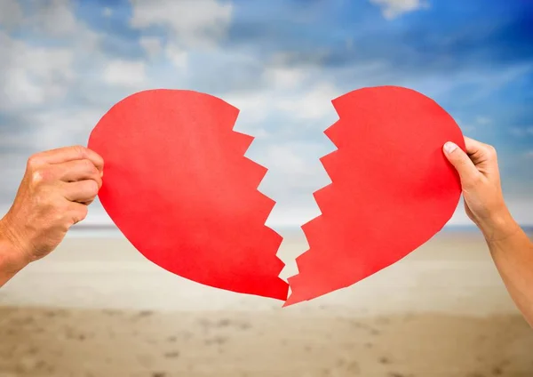 Hands of couple holding broken heart — Stock Photo, Image