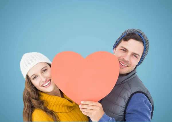 Happy couple holding a red heart — Stock Photo, Image