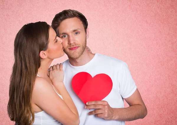 Woman kissing on the cheek of man — Stock Photo, Image