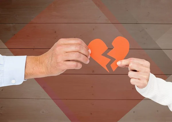 Handen van paar houden van een gebroken hart — Stockfoto