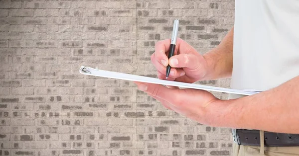 Man writing on a clipboard — Stock Photo, Image