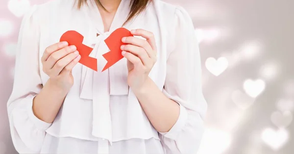 Woman holding a broken heart — Stock Photo, Image