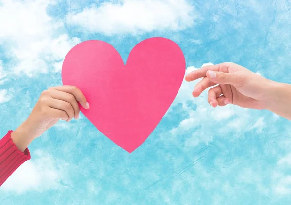 Hand on couple holding pink hearts — Stock Photo, Image