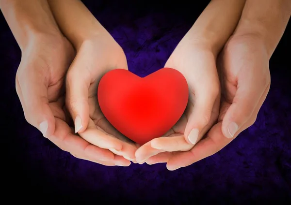 Hands of couple holding a heart — Stock Photo, Image