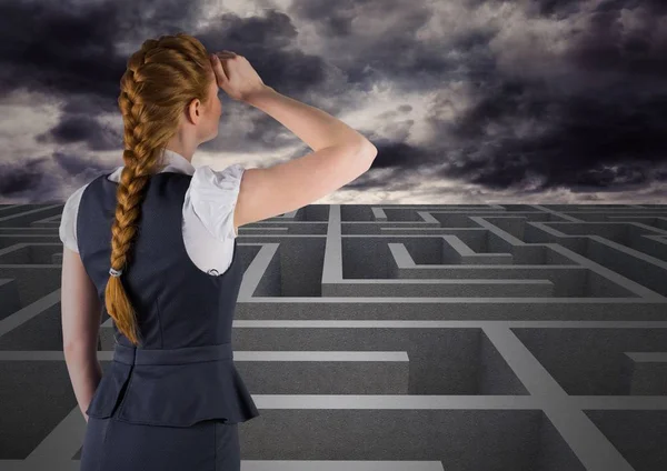 Businesswoman looking over maze — Stock Photo, Image
