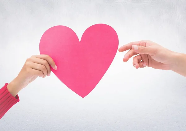 Hands of couple holding a heart — Stock Photo, Image