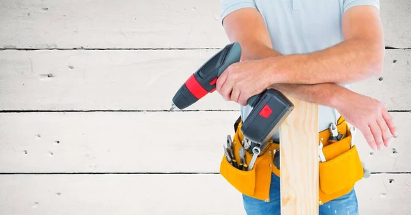 Handyman holding drill machine and plank — Stock Photo, Image