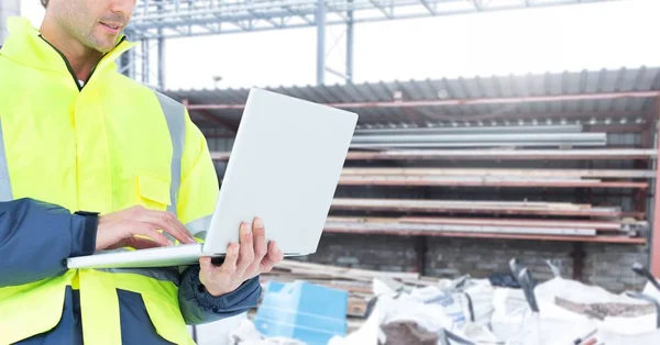 Male architecture using laptop at construction site — Stock Photo, Image