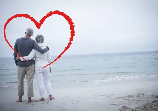 Senior couple embracing each other at beach — Stock Photo, Image