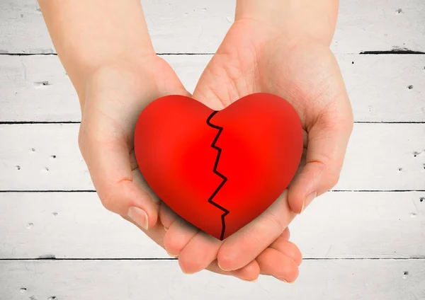Cupped hands holding broken heart — Stock Photo, Image
