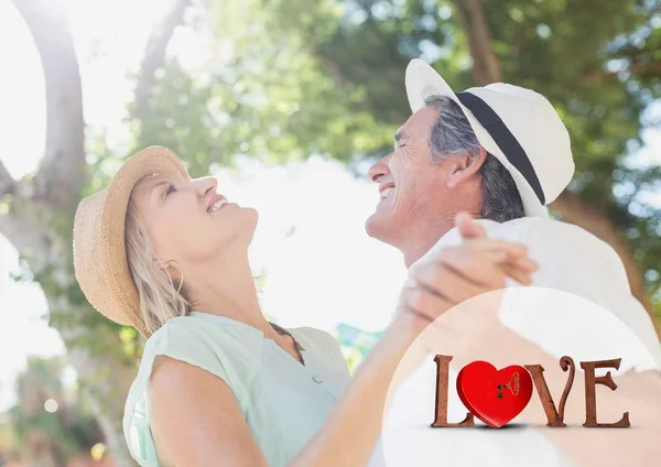 Love text and couple dancing on sunny day — Stock Photo, Image