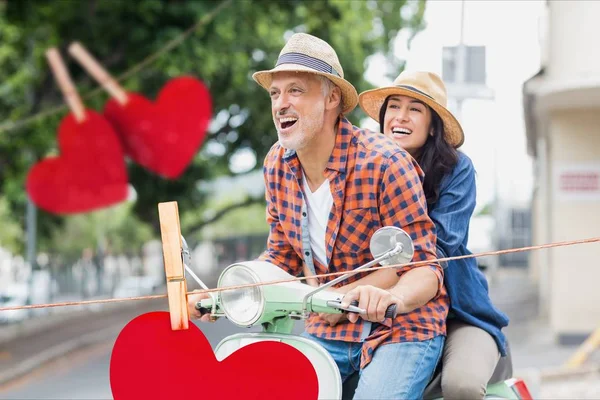 Couple riding on scooter — Stock Photo, Image