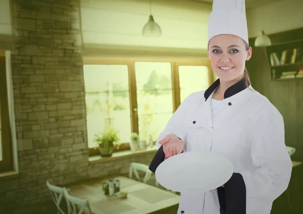 Femme chef souriante tenant une assiette — Photo