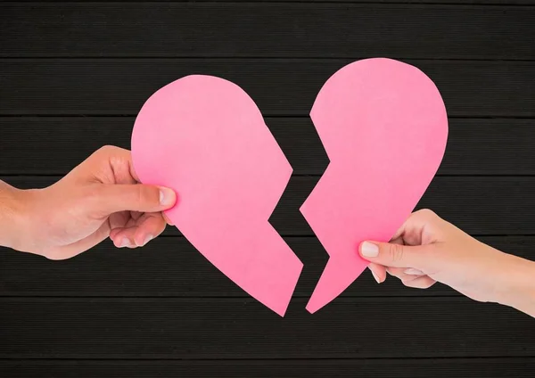 Hands of couple holding broken heart — Stock Photo, Image