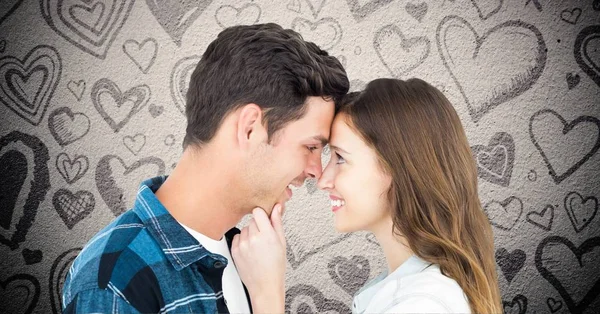 Couple embracing against valentines hearts — Stock Photo, Image