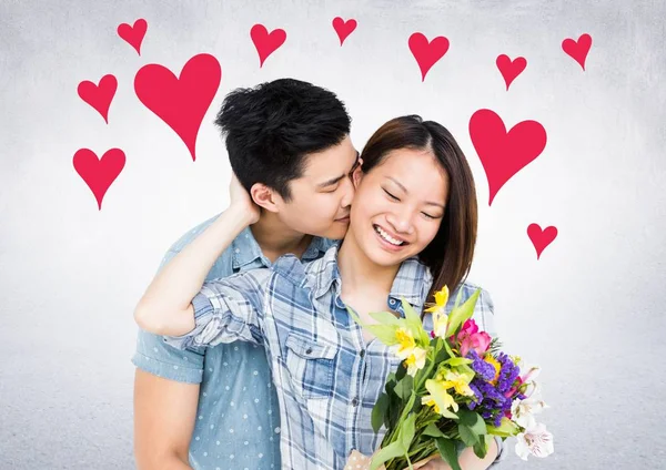 Dvojice drží květiny a líbání — Stock fotografie