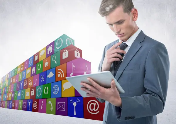 Businessman using tablet with icon block — Stock Photo, Image