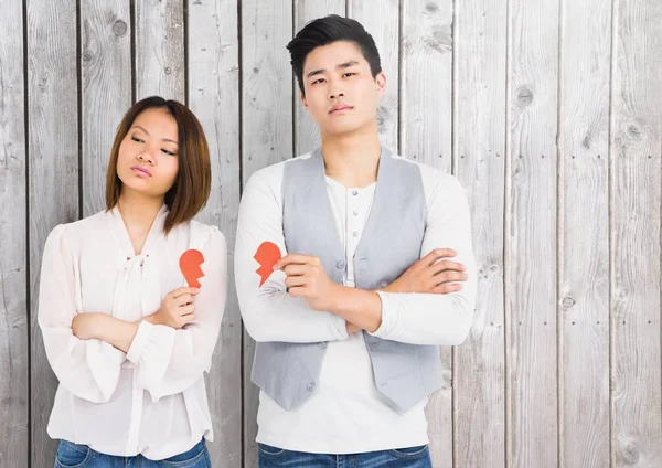 Sad couple holding broken heart — Stock Photo