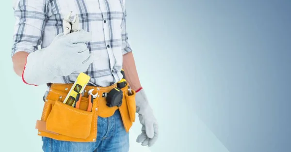 Handyman with tool belt and wrench — Stock Photo, Image