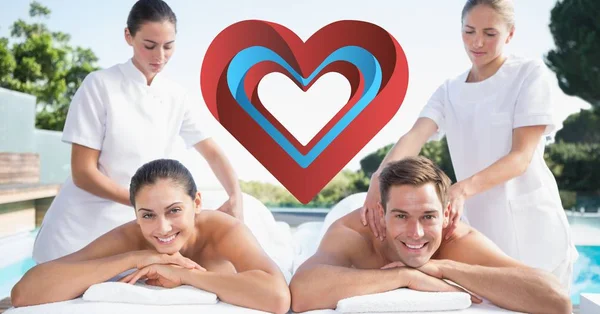 Masseurs giving massage to happy couple — Stock Photo, Image