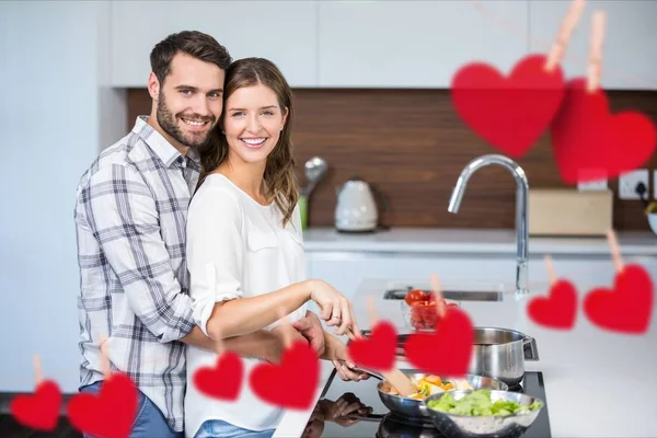 Hanging red heart and couple cooking food — Stock Photo, Image