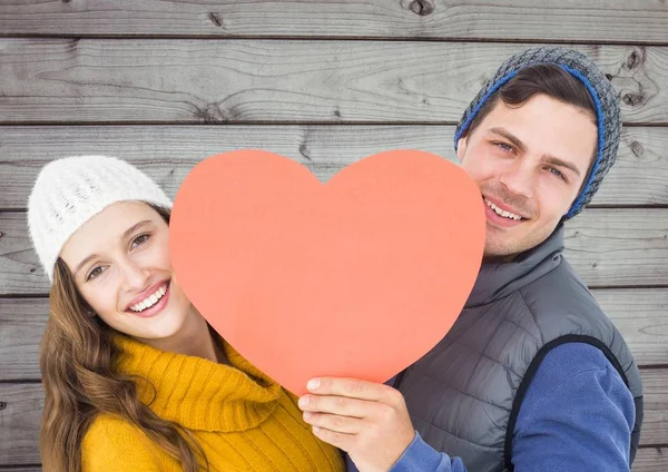 Happy couple holding a red heart — Stock Photo, Image
