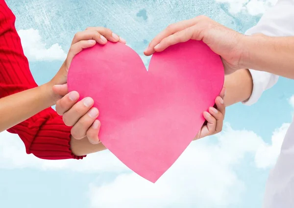 Hand of couple holding red heart — Stock Photo, Image