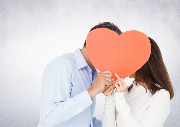 Romantic couple holding heart shape and kissing each other — Stock Photo, Image
