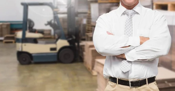 Manager standing with arms crossed in warehouse — Stock Photo, Image