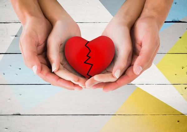 Couple hands holding broken heart — Stock Photo, Image