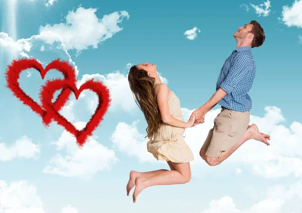 Couple jumping against sky background — Stock Photo, Image