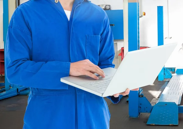 Mid section of mechanic using laptop — Stock Photo, Image