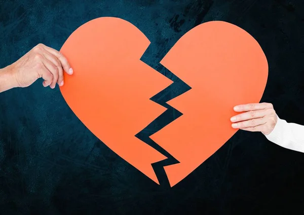 Hand of couple holding broken hearts — Stock Photo, Image