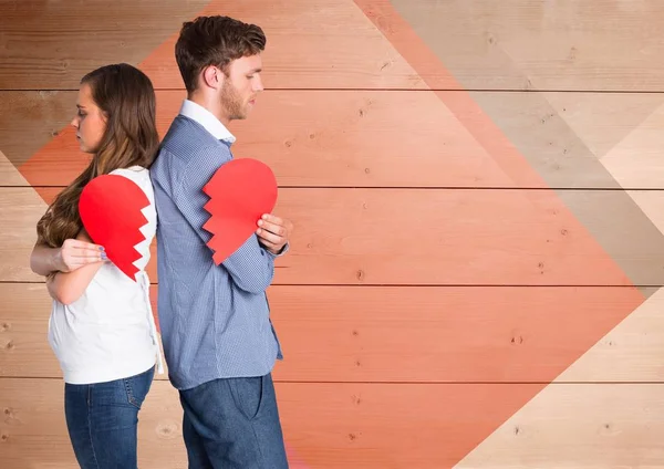 Depressed couple holding broken heart — Stock Photo, Image