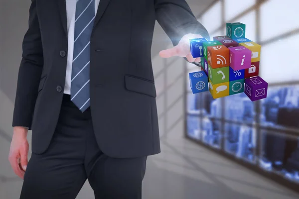 Composietbeeld van mid sectie zakenman aanwijsapparaat kubus met zijn vinger — Stockfoto